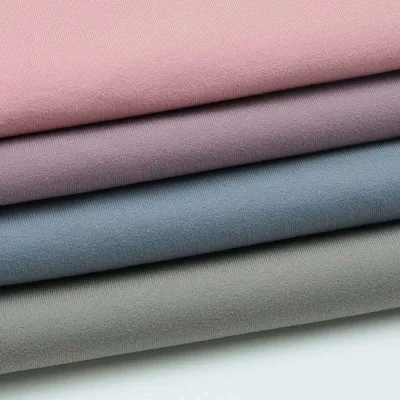 Illustrative stack of activewear fabrics in muted colors